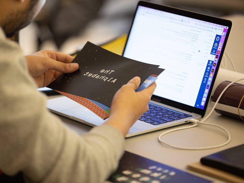 A student prepares print materials.